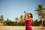 Fit woman drinking water