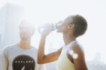 Fitness couple drinking water after workout