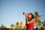 Sportswoman drinking vitamin water