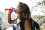 Woman traveler drinking water